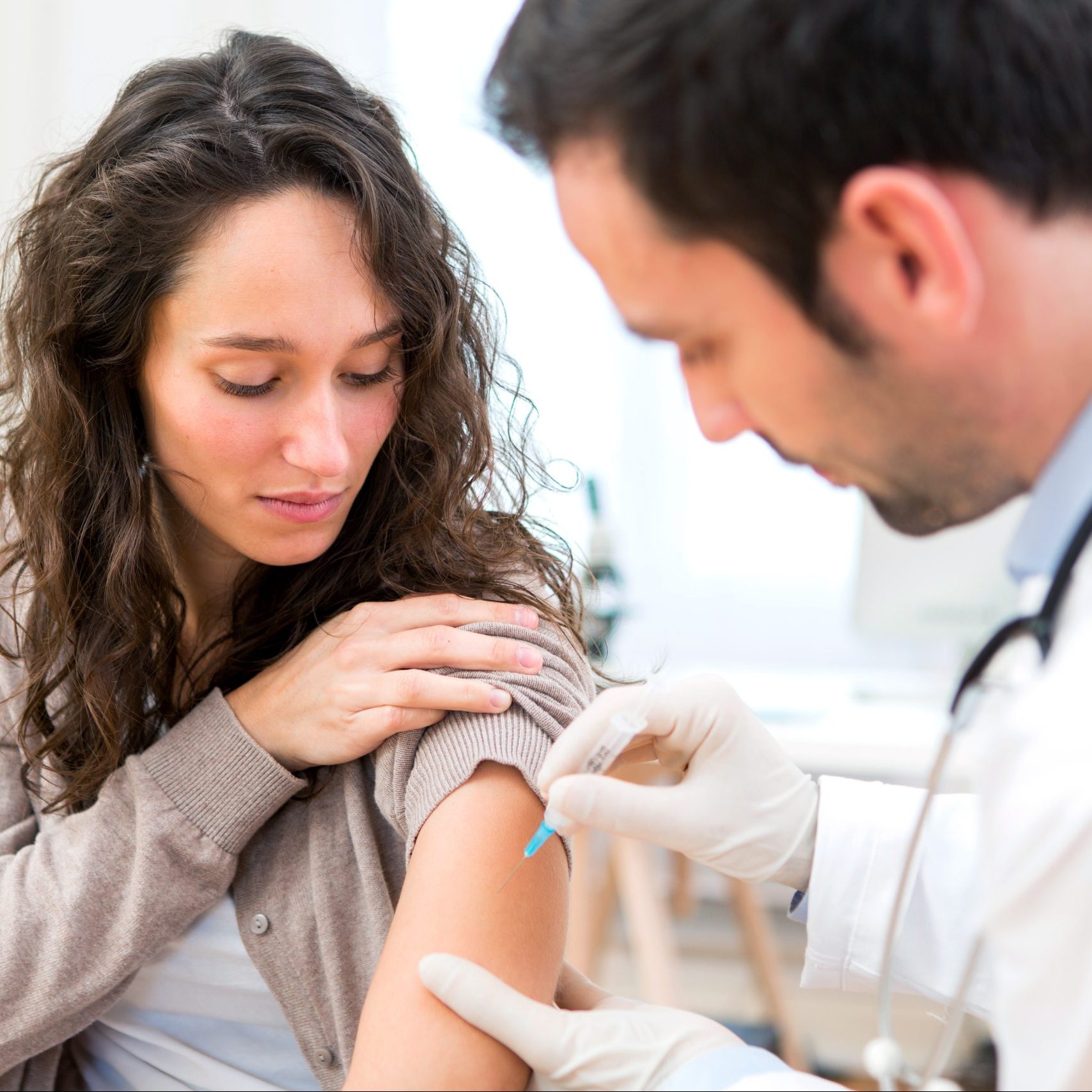 Young attractive woman being vaccinated View of a Young attractive woman being vaccinated